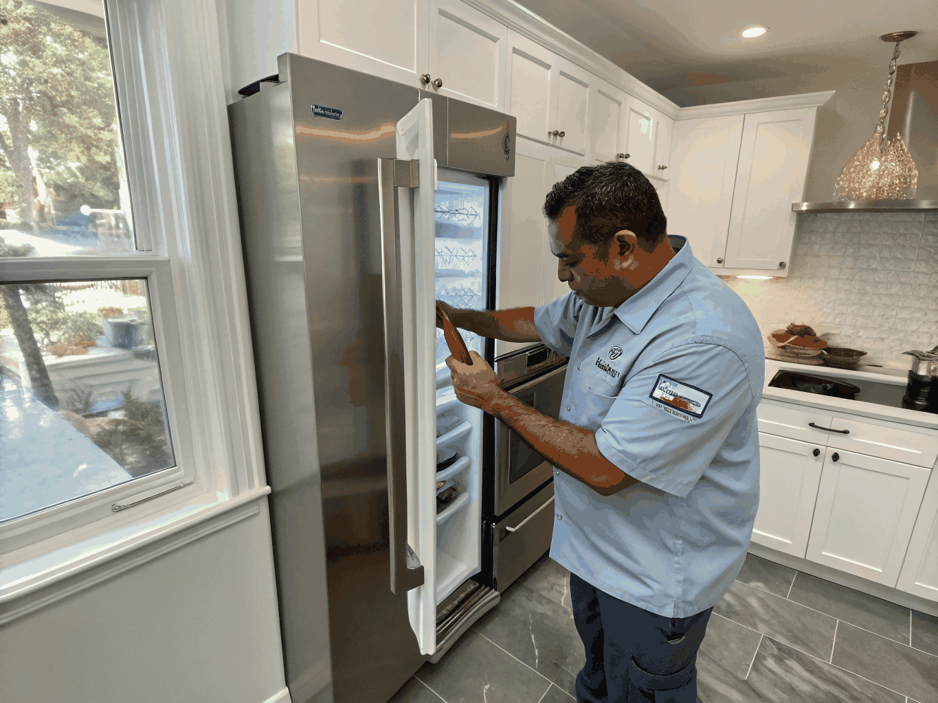 Technician inspecting a modern French door refrigerator cooling system